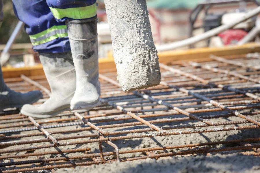 Concrete being pumped onto reinforcing on site
